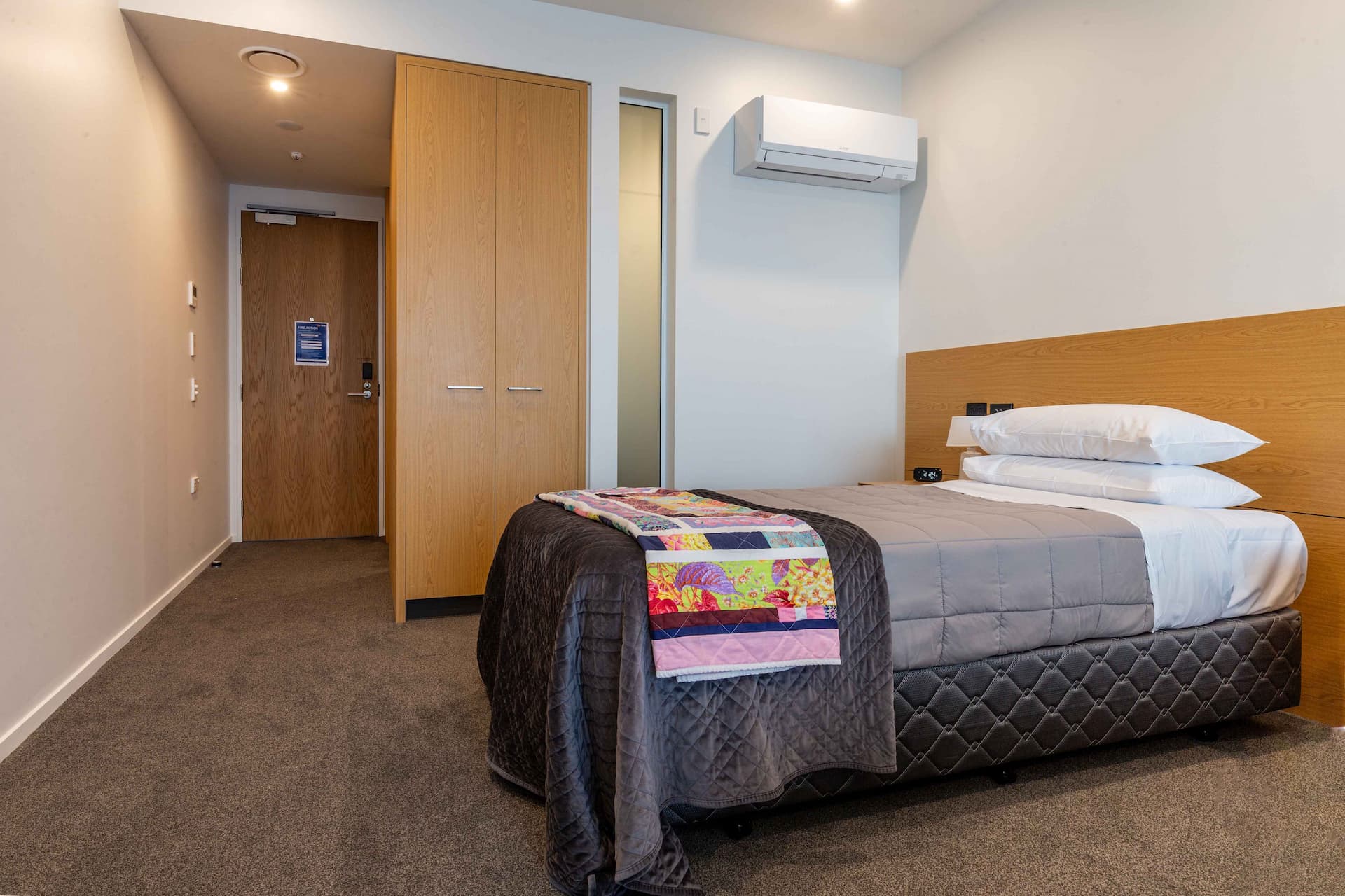 Single bedroom with custom wardrobe at Cancer Care accommodation