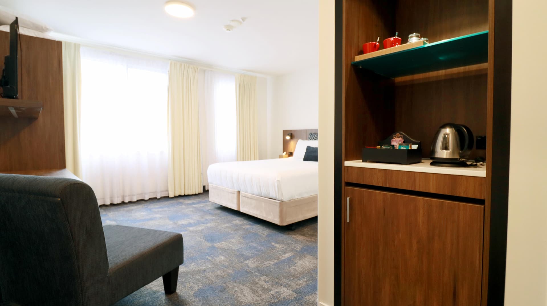 Guest room minibar and lounge area at Jet Park Hotel Rotorua